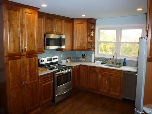 11 Hazel Drive Patterson, NY 12563 - Photo 12 of 20 a kitchen with stainless steel appliances granite countertop wooden cabinets a sink a stove a refrigerator with grey cabinets and wooden floor