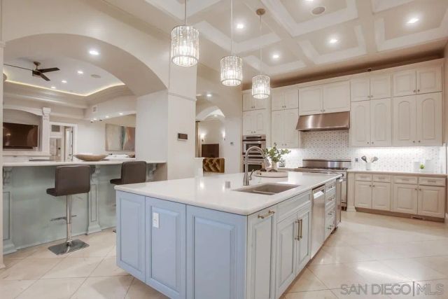 a kitchen with granite countertop a counter space dining table and stainless steel appliances