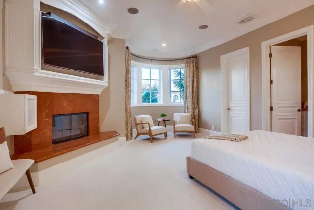a bedroom with a bed and a fireplace