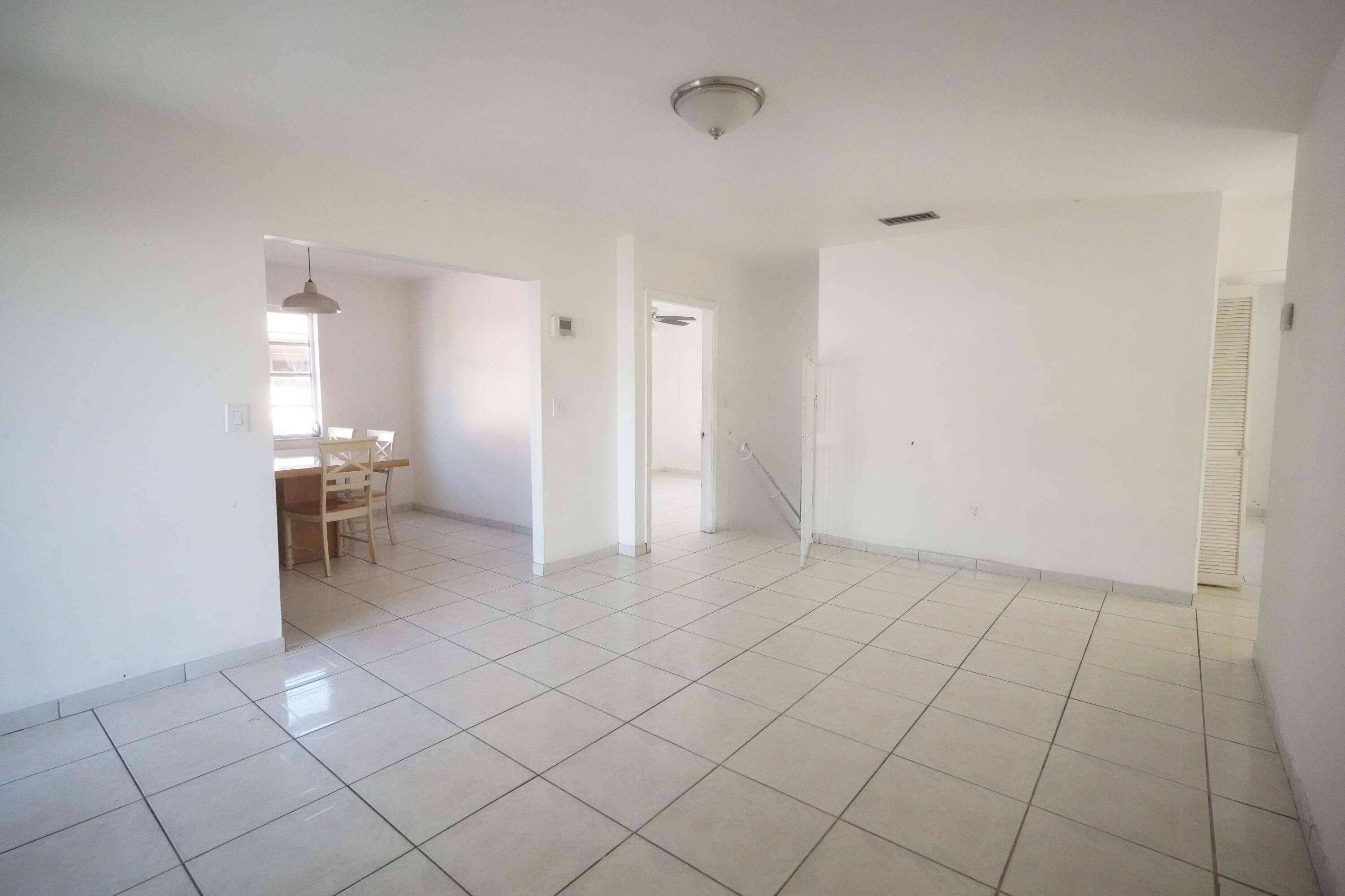 a view of an empty room and bathroom