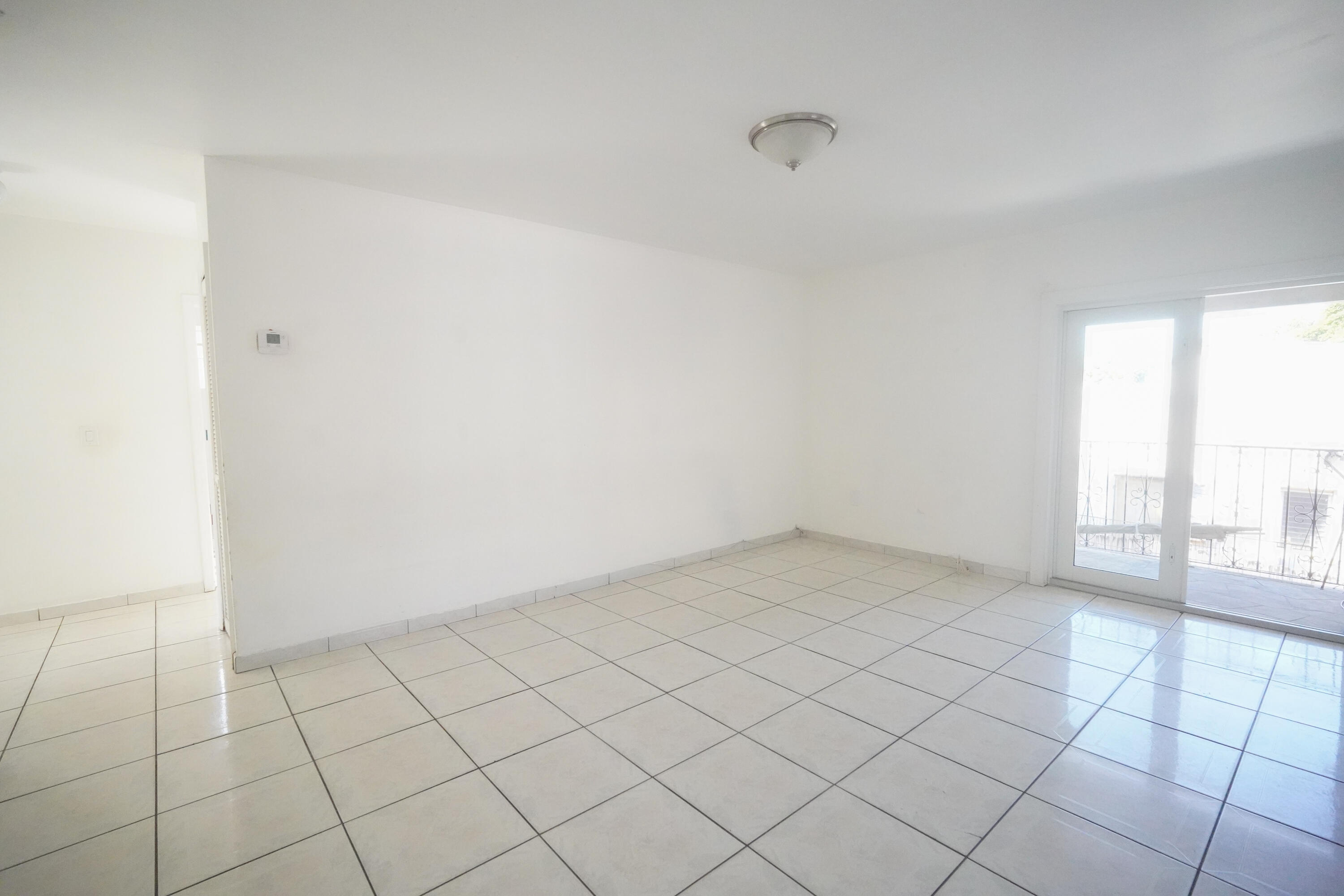 1882 Southwest 17th Avenue Miami, FL 33145 - Photo 3 of 28 a view of an empty room and window