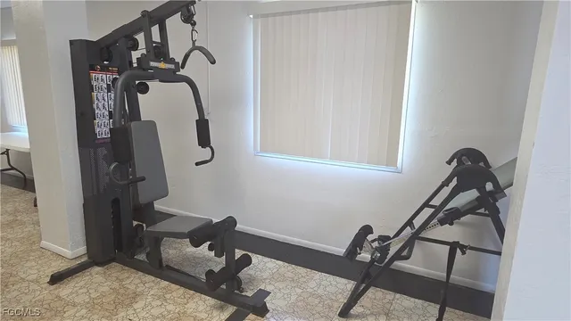 a room with chairs pool table and windows