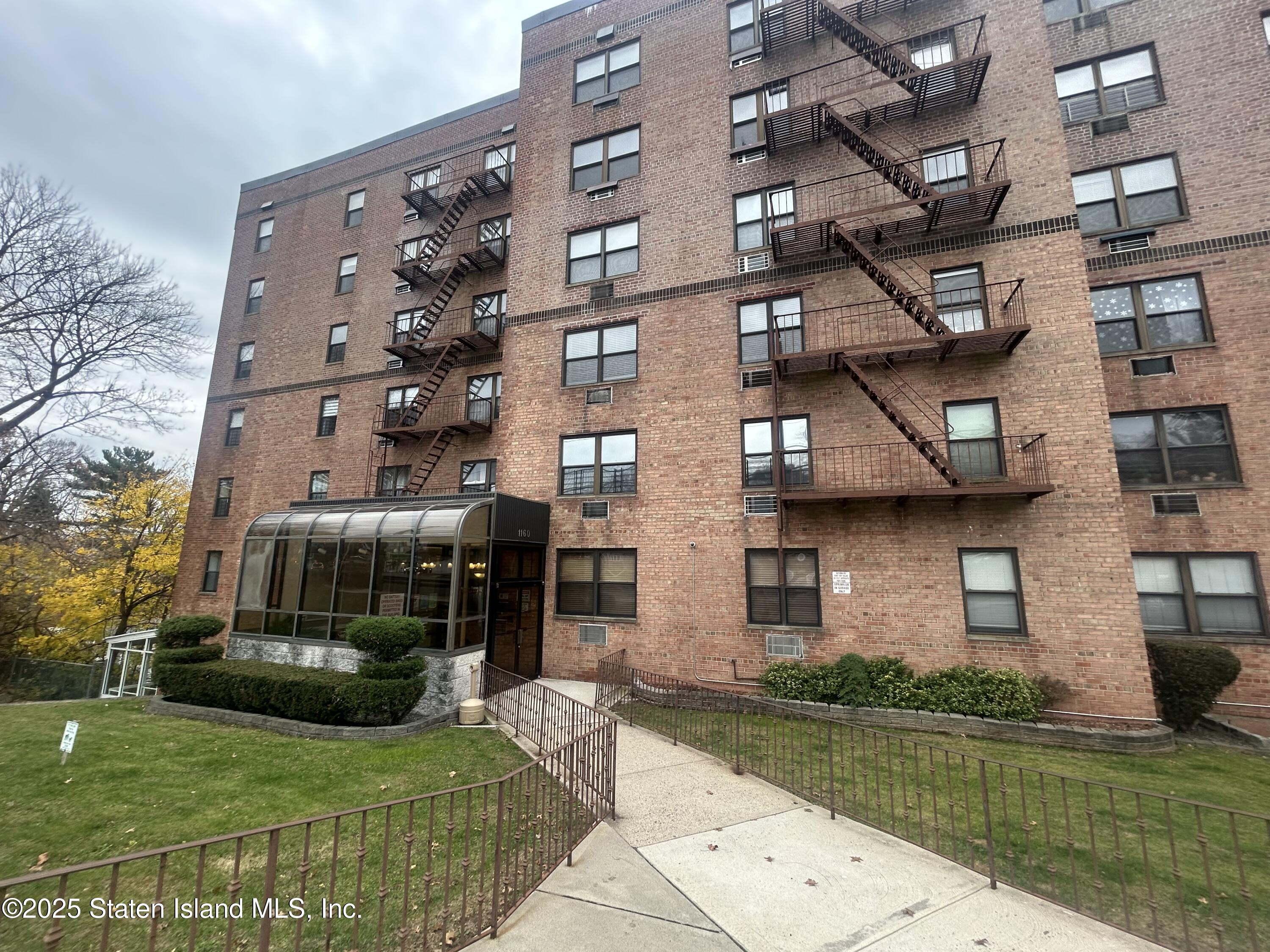 1160 Richmond Road, Unit 6A Staten Island, NY 10304 - Photo 1 of 14 a view of a building with a yard
