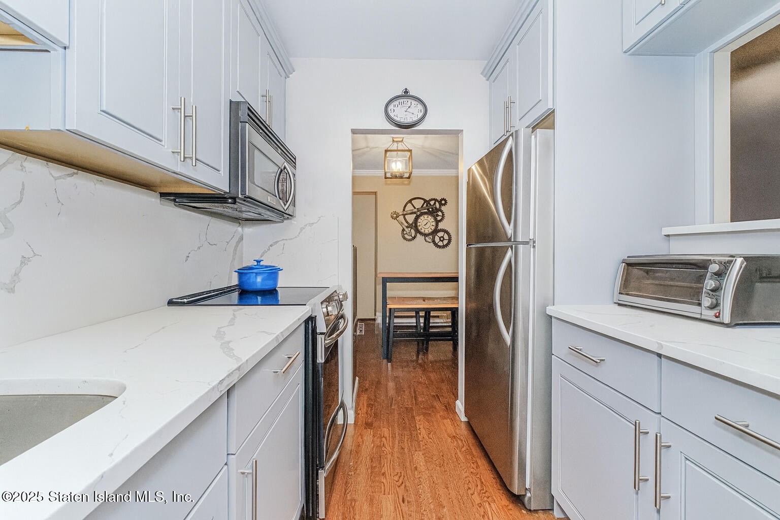 1160 Richmond Road, Unit 6A Staten Island, NY 10304 - Photo 6 of 14 a kitchen with stainless steel appliances granite countertop a refrigerator and a stove top oven