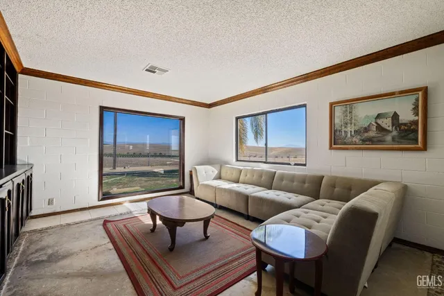 a living room with furniture and kitchen view