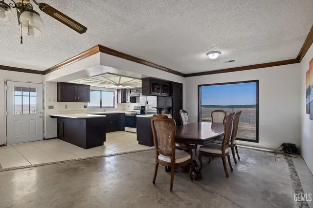 a kitchen with stainless steel appliances a stove a sink a microwave and a refrigerator