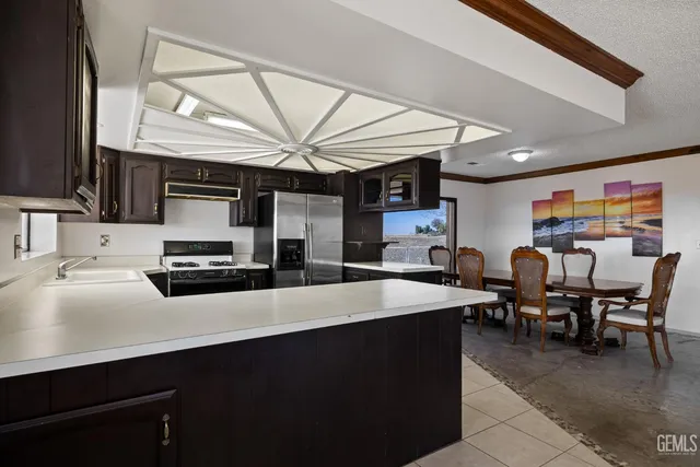 a kitchen with a table and chairs