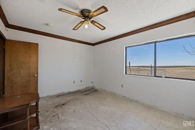 a view of room with a ceiling fan and window