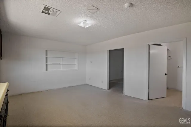 a view of a kitchen with a refrigerator and a cabinets