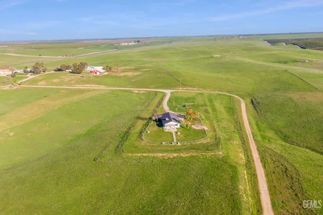 a living room with stainless steel appliances kitchen island granite countertop a sink and a stove top oven
