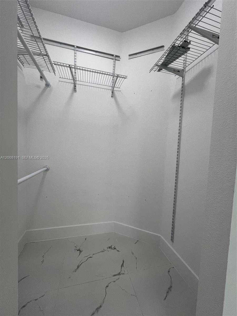 20007 Southwest 122nd Court, Unit 20007B Miami, FL 33177 - Photo 6 of 9 a view of a room with racks on the wall