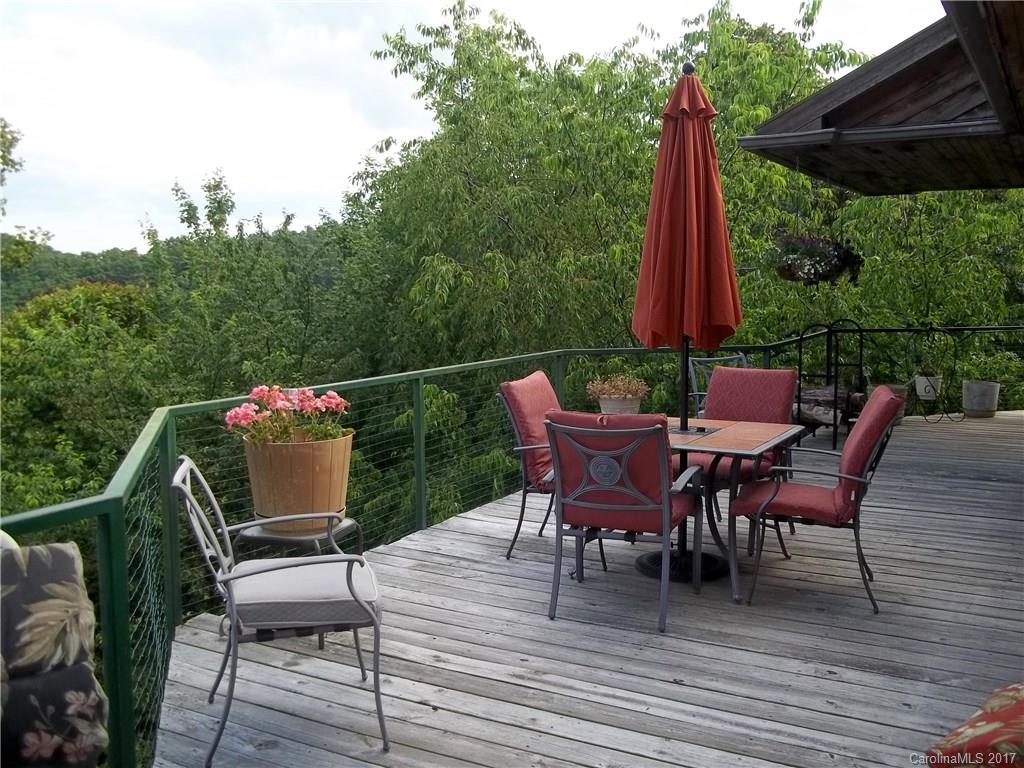 8 Elmers Place Fairview, NC 28730 - Photo 2 of 21 a view of a patio with a table chairs and a wooden deck