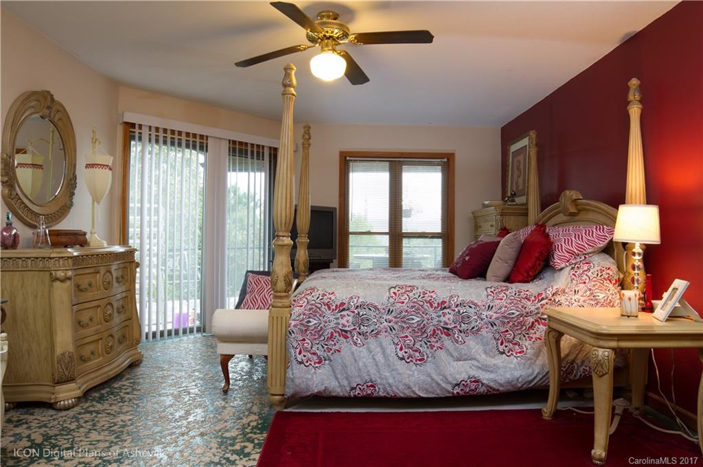 8 Elmers Place Fairview, NC 28730 - Photo 12 of 21 a bedroom with a bed and dresser with mirror