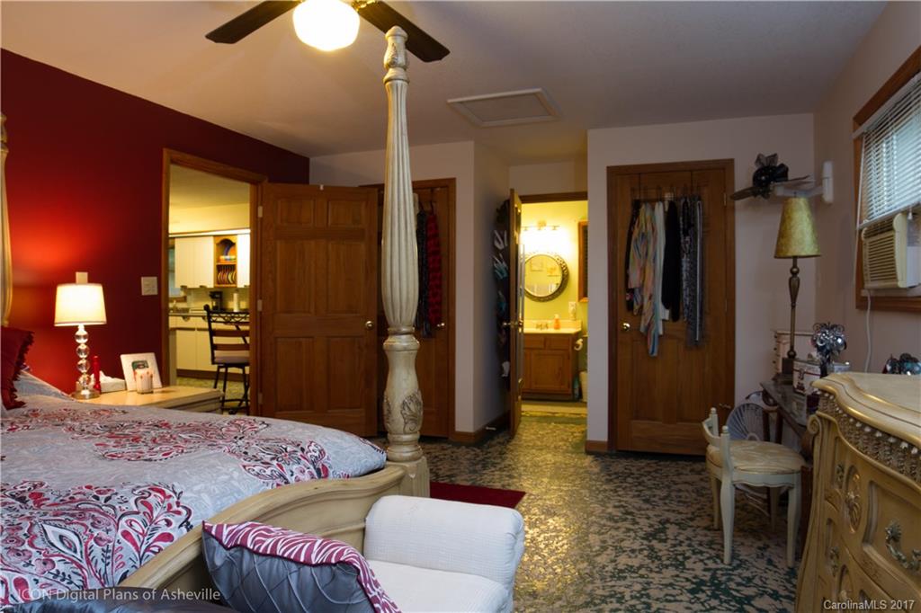 8 Elmers Place Fairview, NC 28730 - Photo 13 of 21 a bedroom with a bed and a chandelier