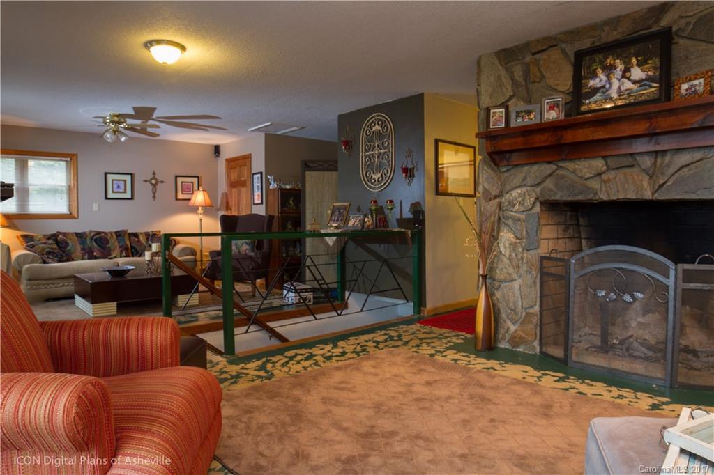 8 Elmers Place Fairview, NC 28730 - Photo 16 of 21 a living room with furniture a flat screen tv and a fireplace