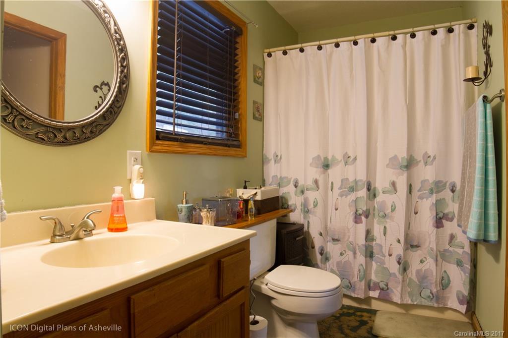 8 Elmers Place Fairview, NC 28730 - Photo 19 of 21 a bathroom with a sink and a mirror
