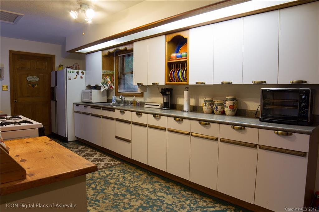 8 Elmers Place Fairview, NC 28730 - Photo 9 of 21 a kitchen with stainless steel appliances granite countertop a sink and cabinets