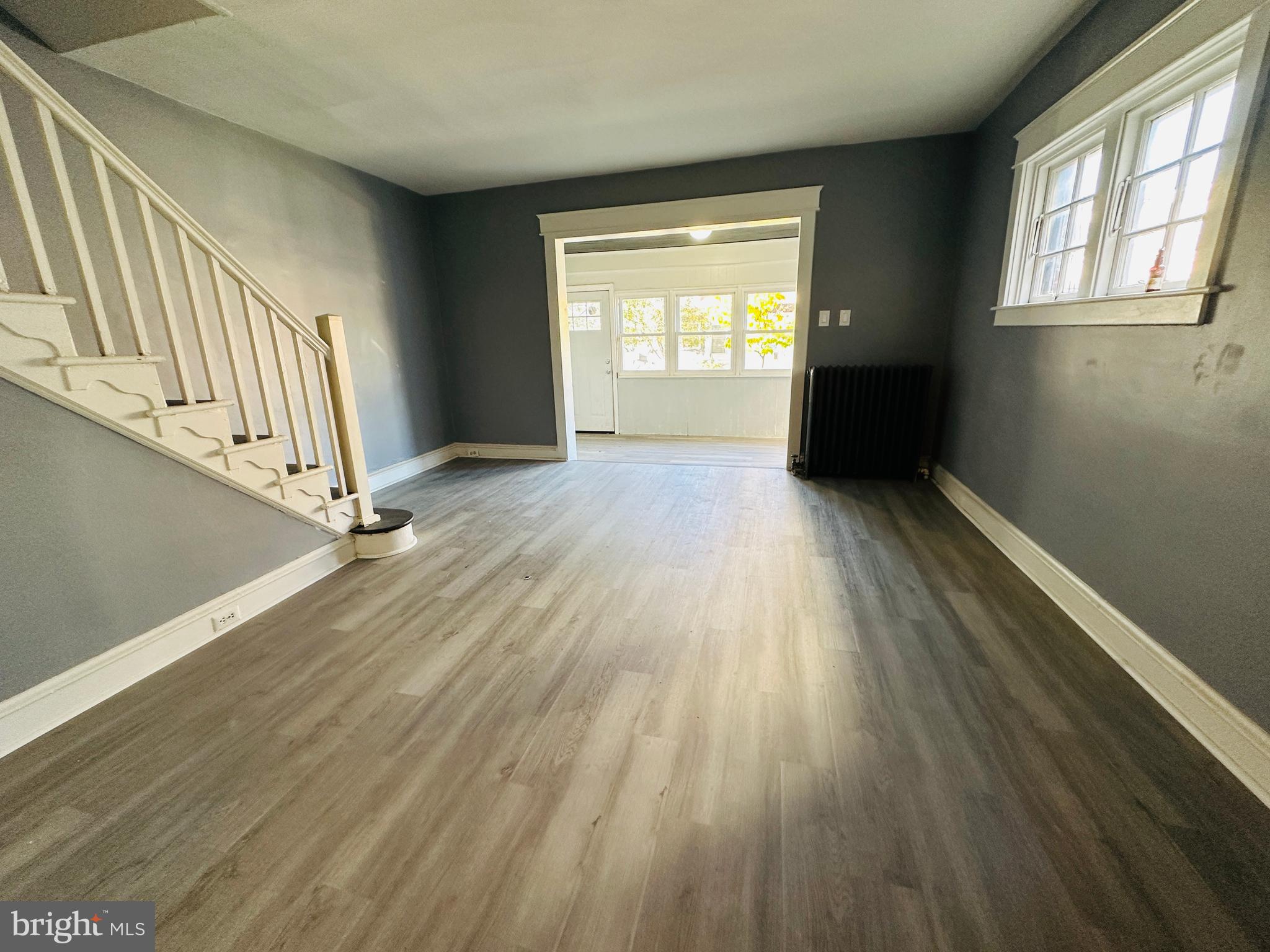 149 Wayne Avenue Collingdale, PA 19023 - Photo 6 of 28 an empty room with wooden floor and windows