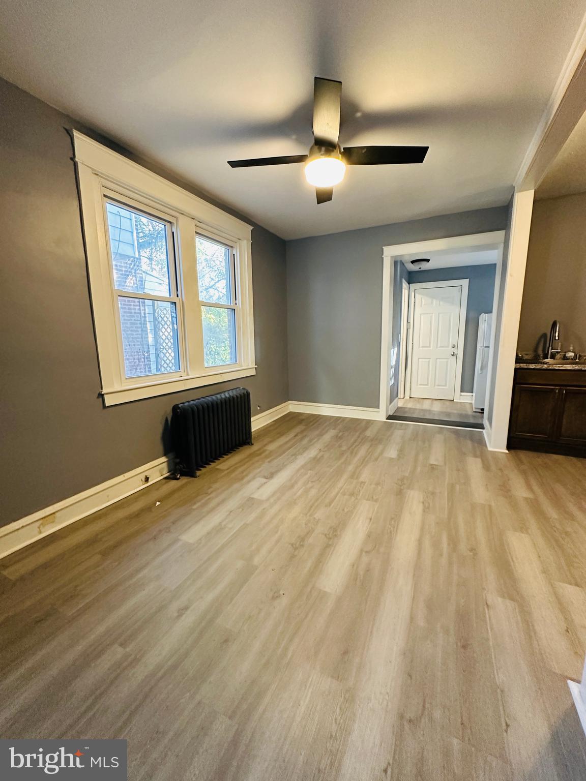 149 Wayne Avenue Collingdale, PA 19023 - Photo 8 of 28 a view of an empty room with a window and wooden floor