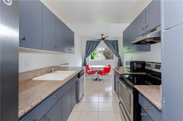 a bathroom with a granite countertop sink a toilet and shower