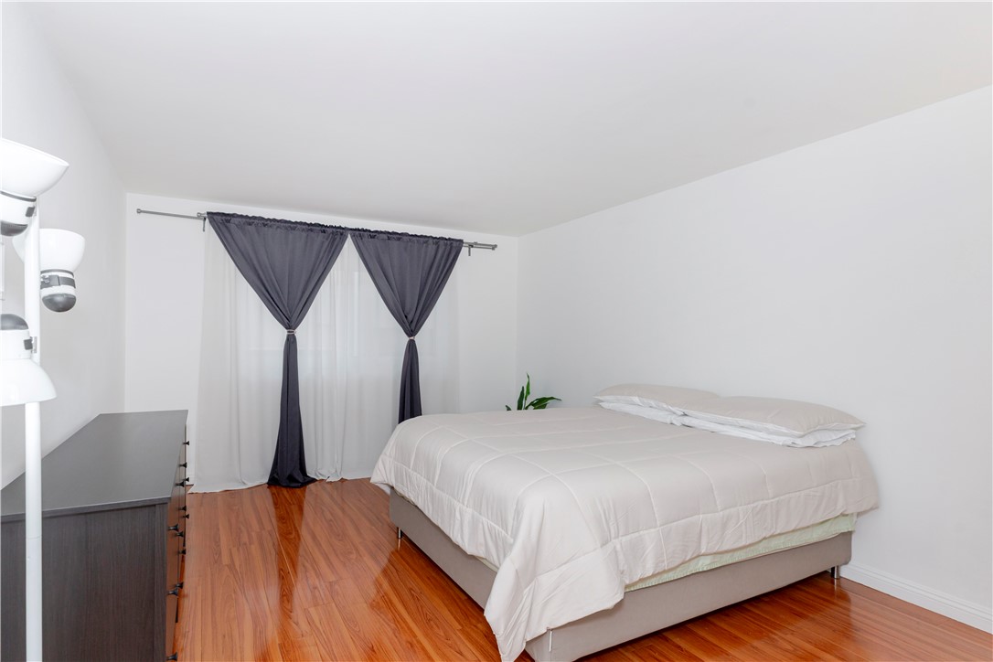 5400 Newcastle Avenue, Unit 70 Encino, CA 91316 - Photo 19 of 32 a bedroom with a bed and wooden floor