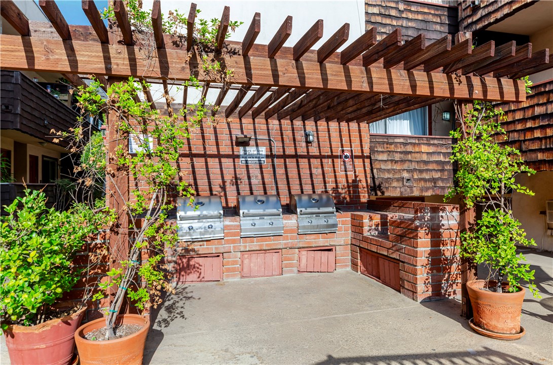 5400 Newcastle Avenue, Unit 70 Encino, CA 91316 - Photo 22 of 32 a view of a backyard with a chair and potted plants