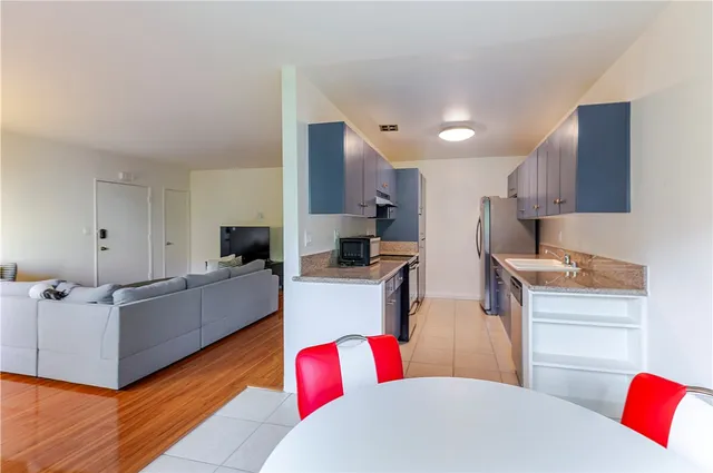 a living room with furniture and kitchen view