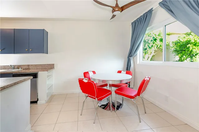 a view of a dining room with furniture a rug and wooden floor