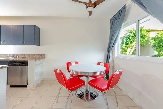 a kitchen with a chair a table and chairs