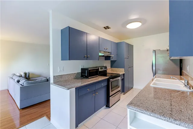 a kitchen with a sink and a refrigerator