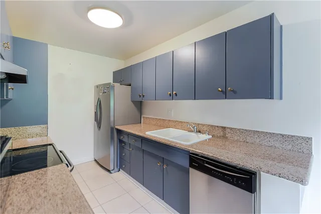 a kitchen with a sink stove top oven and cabinets