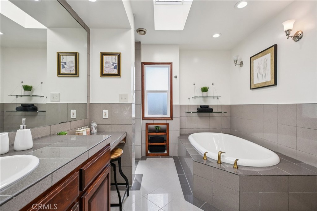 367 Ultimo Avenue Long Beach, CA 90814 - Photo 24 of 37 a bathroom with a granite countertop tub sink and mirror