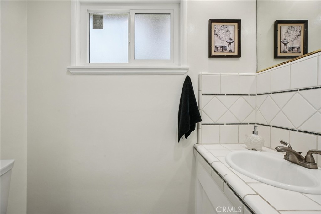 367 Ultimo Avenue Long Beach, CA 90814 - Photo 29 of 37 a bathroom with a sink and a window