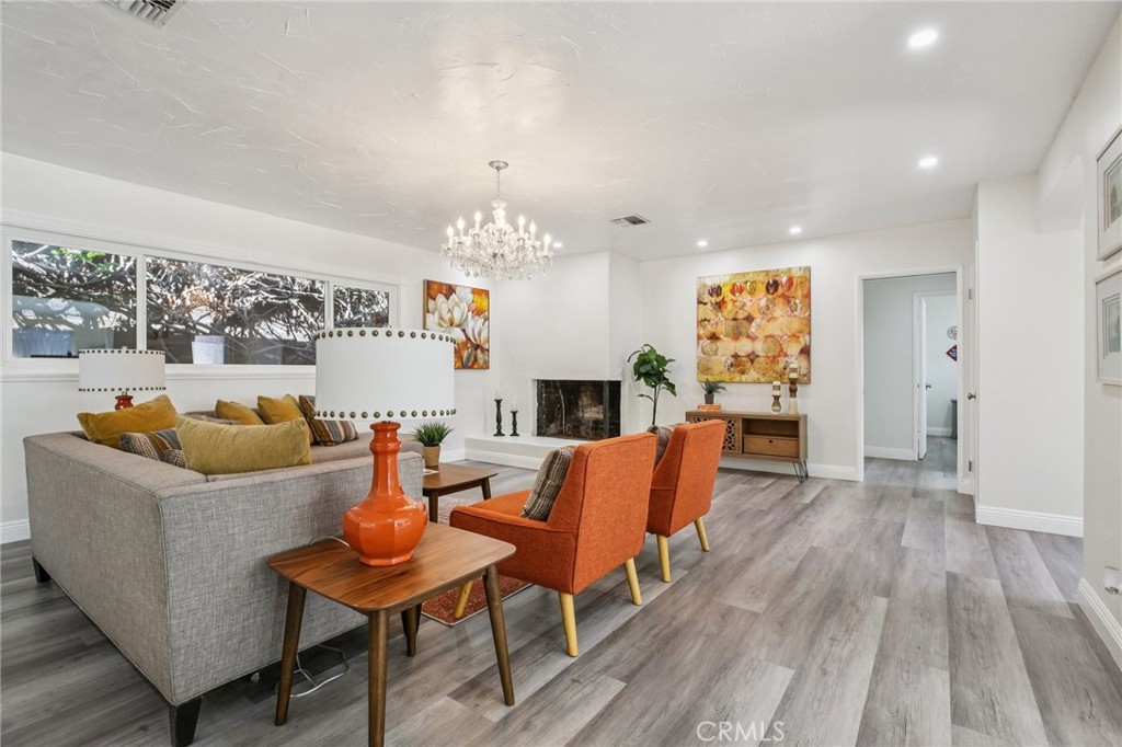 367 Ultimo Avenue Long Beach, CA 90814 - Photo 4 of 37 a living room with fireplace furniture and a chandelier