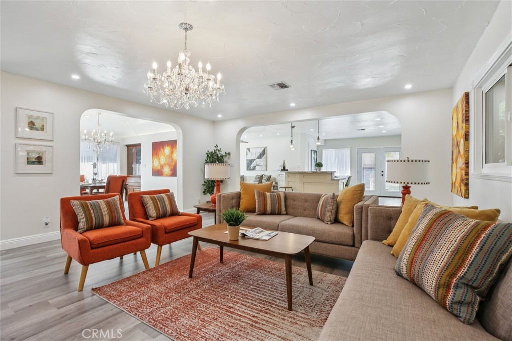367 Ultimo Avenue Long Beach, CA 90814 - Photo 7 of 37 a living room with furniture kitchen view and a chandelier