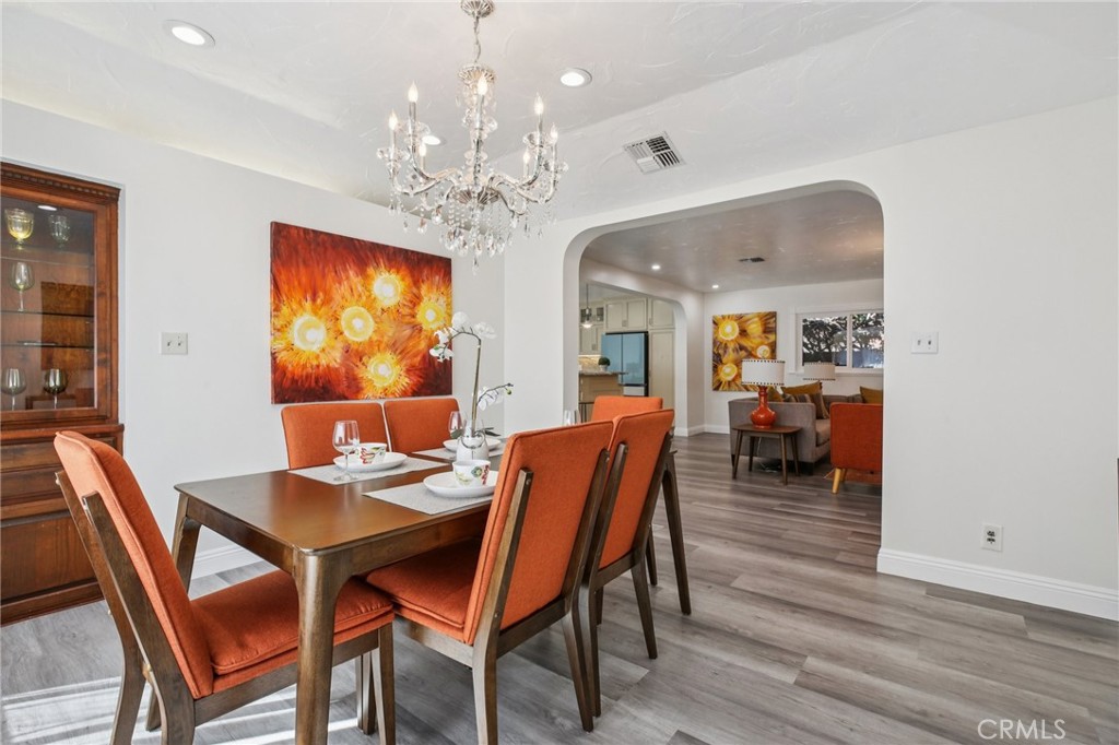 367 Ultimo Avenue Long Beach, CA 90814 - Photo 9 of 37 a view of a dining room with furniture a chandelier and wooden floor