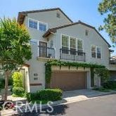a front view of a house with a garden and plants