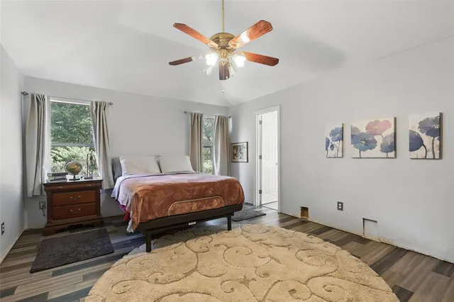 a bed room with a bed and a large window