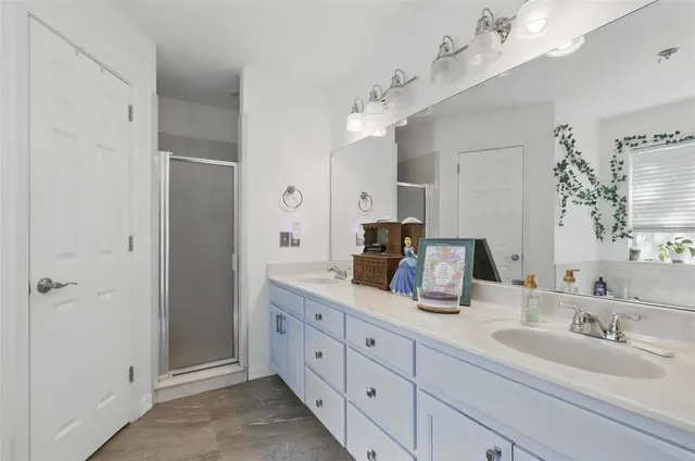 a bathroom with a double vanity sink mirror and double