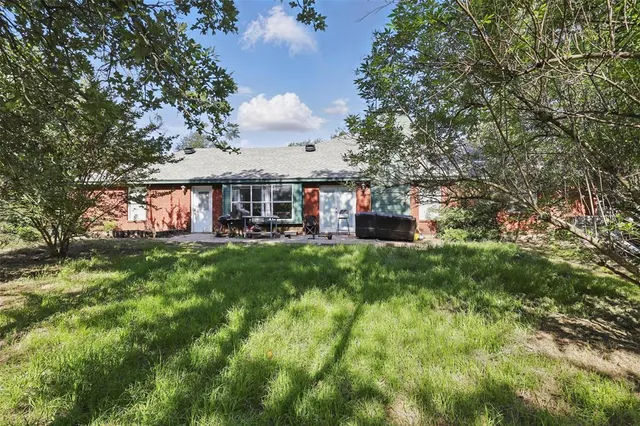 a view of a house with a backyard
