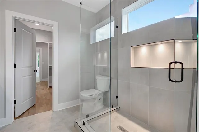 a bathroom with a shower and toilet