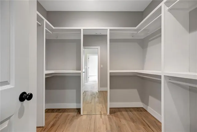 a spacious bathroom with a double vanity sink mirror and shower