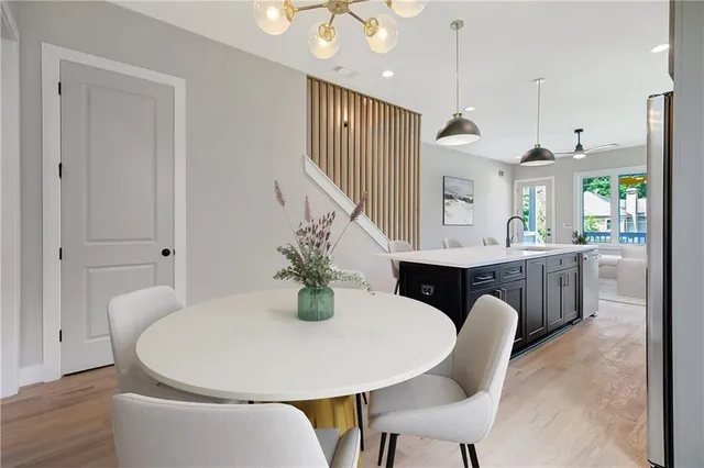 a living room with furniture a large window and wooden floor