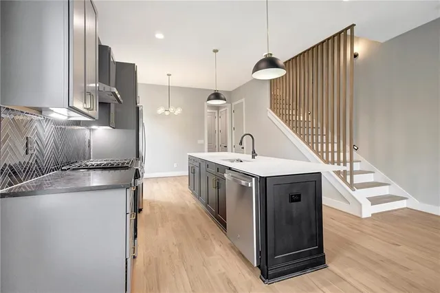 a kitchen with a stove a sink and a refrigerator
