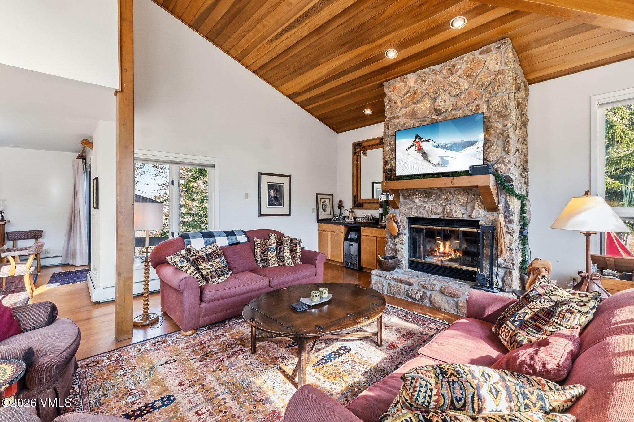 1460 Ridge Lane, Unit D Vail, CO 81657 - Photo 5 of 18 a living room with furniture a flat screen tv and a fireplace