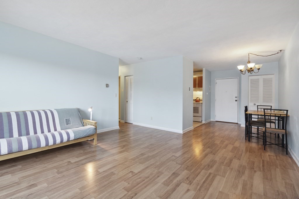 110 Boston Post Road East, Unit 201 Marlborough, MA 01752 - Photo 3 of 14 a living room with furniture and a wooden floor