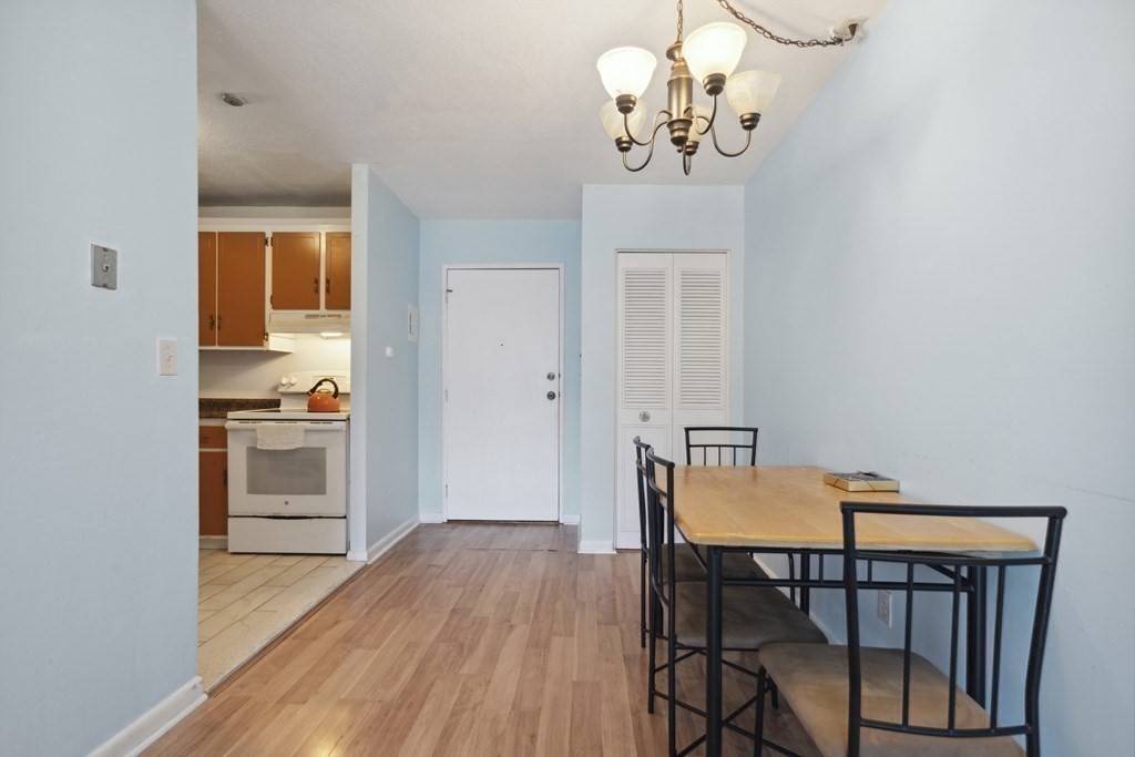110 Boston Post Road East, Unit 201 Marlborough, MA 01752 - Photo 5 of 14 a view of a dining room with furniture wooden floor and chandelier