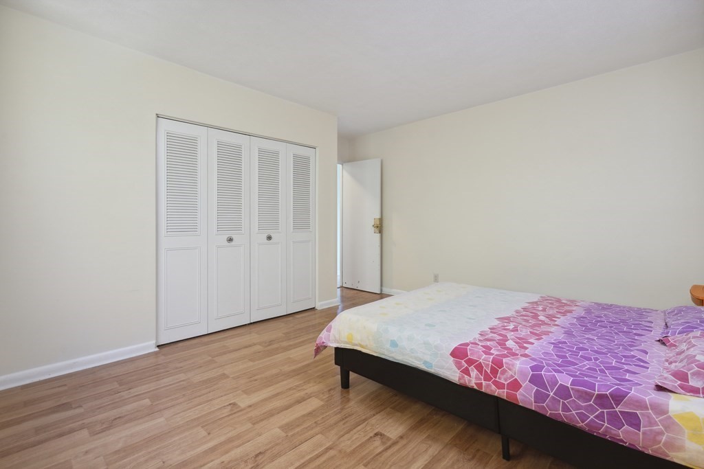 110 Boston Post Road East, Unit 201 Marlborough, MA 01752 - Photo 8 of 14 a bedroom with a bed and a potted plant