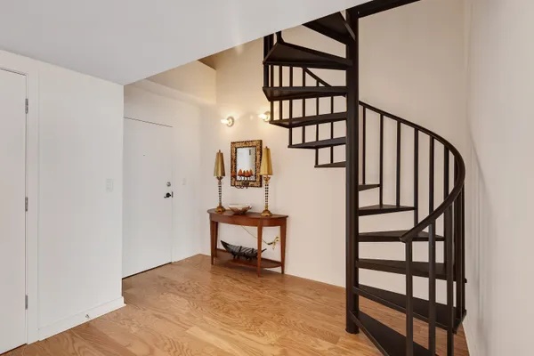 a view of entryway with wooden floor and stairs