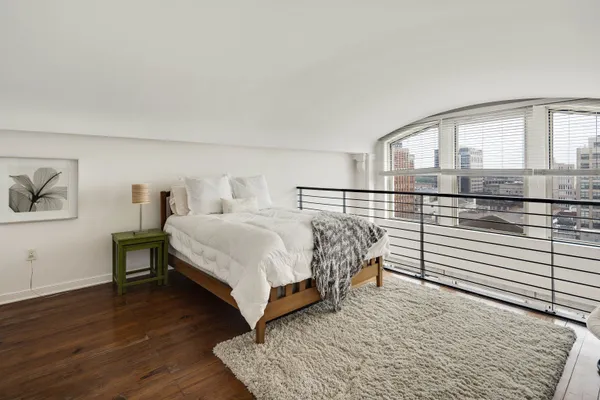 a bedroom with a bed and a chair